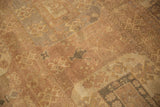 Time-softened texture of a distressed Oushak carpet with visible knot heads.