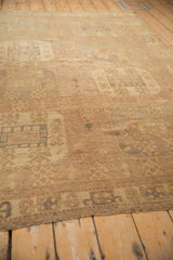 Visible knot heads and low-pile texture of a vintage distressed hand-knotted Oushak carpet.