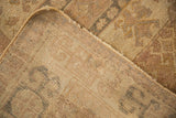 Corner view of a vintage Oushak showing its low pile and hand-knotted woven foundation.