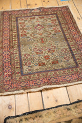 Angled view showcasing the Kufic border and geometric field of a vintage Shirvan rug mat.