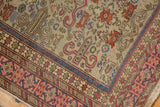 Detail of the intricate hand-knotting, Kufic border, and signature on a vintage Shirvan rug.