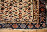 Corner of an antique Kurdish rug with even wear to knot heads, geometric borders, and short fringe.