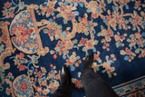 Blush and terracotta floral branches sprawl across the cobalt blue field of this vintage Art Deco carpet.