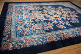 Stylized dragon and intricate floral border on a vintage Chinese Art Deco cobalt blue carpet.