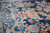 Dragon and floral details on the short, cobalt blue pile of a vintage Chinese Art Deco carpet.