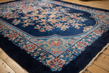 Intricate floral and geometric corner border of a cobalt blue Art Deco carpet.