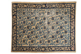 Antique Peking carpet with a scrolling vine trellis in shades of blue on a worn, antique ivory field.