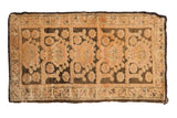 Vintage Kars rug fragment with a distressed, textured pile showing a geometric cloudband design in dusty rose and chocolate brown.