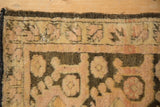 Corner of a distressed Kars rug showing worn pile, exposed foundation, and secured brown edges.