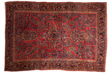 Antique American Sarouk carpet with an allover floral pattern in sapphire and navy blue on a raspberry red field.
