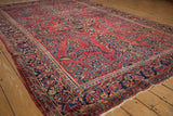 Lustrous pile of an antique Sarouk carpet with raspberry red and sapphire blue floral bouquets.