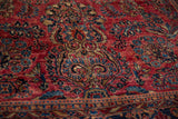 High luster pile and intricate floral sprays on a raspberry red antique American Sarouk carpet.