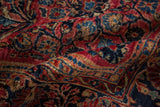 Plush, lustrous wool pile showing floral details on an antique Sarouk carpet.