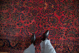 Close-up view of the low pile and allover floral sprays in raspberry red and navy blue.