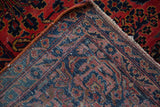 Folded corner of an antique Persian Sarouk reveals its hand-knotted construction and foundation.