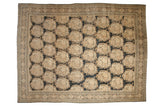Antique distressed Tabriz carpet with Rococo stylized roundels of rose bouquets on a dark charcoal field.