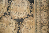 Low-pile texture of a distressed Tabriz carpet revealing Rococo rose bouquets in ivory and charcoal.