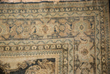 Corner of a distressed antique Tabriz with complex borders and a time-worn tattered edge.