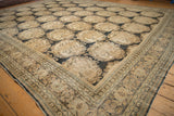 The low, worn pile and detailed corner of a European-influenced antique Tabriz carpet.
