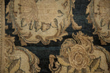 Hand-knotted texture and worn pile on Rococo-stylized motifs in ivory and charcoal.