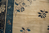 Worn pile and visible foundation on an antique Peking carpet beside a navy blue border.