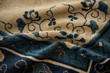 Close-up of the plush pile and cobalt blue vines on an antique ivory Peking carpet.