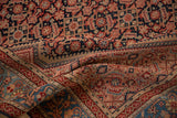 Intricate Herati field and vine border detail on a draped antique fine Malayer rug.