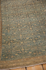 Antique Malayer rug corner detail: dusty teal Herati field, banded wave and vine borders, even wear.