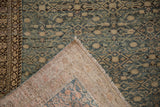 Antique Distressed Malayer rug detail, folded to show worn Herati pattern and tightly woven foundation.