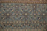 Distressed pile on an antique Malayer rug, featuring a reciprocating wave border and dusty blue Herati field.