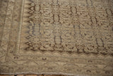 Distressed Malayer rug corner with silver and cream geometric border and Herati pattern.