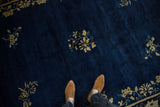 A perspective view showing the deep cobalt blue pile and scattered floral sprays of an antique Peking carpet.