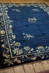 Antique Peking carpet corner detail showing the floral border and visible side foundation.