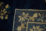 Antique Peking carpet corner showing the cobalt pile and reverse hand-knotted foundation.