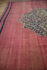 The low, even wear of the raspberry red pile on this antique Doroksh rug runner.