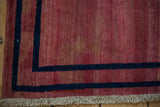 Corner of an antique Persian rug showing even wear to the knot heads and restored ivory fringe.