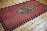 Antique Doroksh rug runner with a central medallion and finished selvages along its full length.