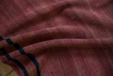 Even wear across the hand-knotted pile showing raspberry red and navy blue bands.
