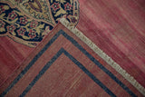 Hand-woven foundation of an antique Doroksh rug in raspberry and navy with side fringe.