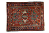 Vintage Persian Karaja rug with a triple medallion design in cherry red, emerald green, and navy blue.