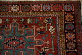 Fine details of the serpent border on a vintage Karaja rug in emerald green and navy blue.
