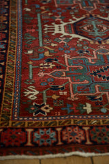 Angled view across the low pile of a vintage Karaja rug's geometric serpent border.