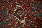 Fine details of the geometric hook and latch medallion on a hand-knotted Karaja Persian rug.