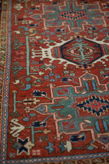 Close view of the serpent border and finely drawn geometric motifs on a vintage Karaja rug.