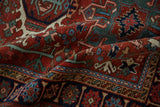 Detail of the intricate serpent border and hand-knotted pile on a vintage Karaja rug.