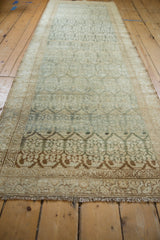 Lengthwise view of a distressed Malayer runner with visible abrash in dusty teal and coffee brown.