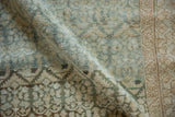Angled view highlighting the distressed pile and boteh pattern on a vintage Malayer runner.