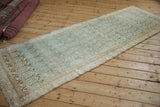 Distressed Persian Malayer runner laid out to show its allover boteh pattern and softly rippled texture.