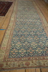 Distressed antique Kurdish Hamadan runner detail: sapphire blue geminating plants and beige border.