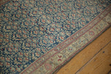 Distressed texture of blue and ivory geminating plants on an antique Kurdish Hamadan rug.